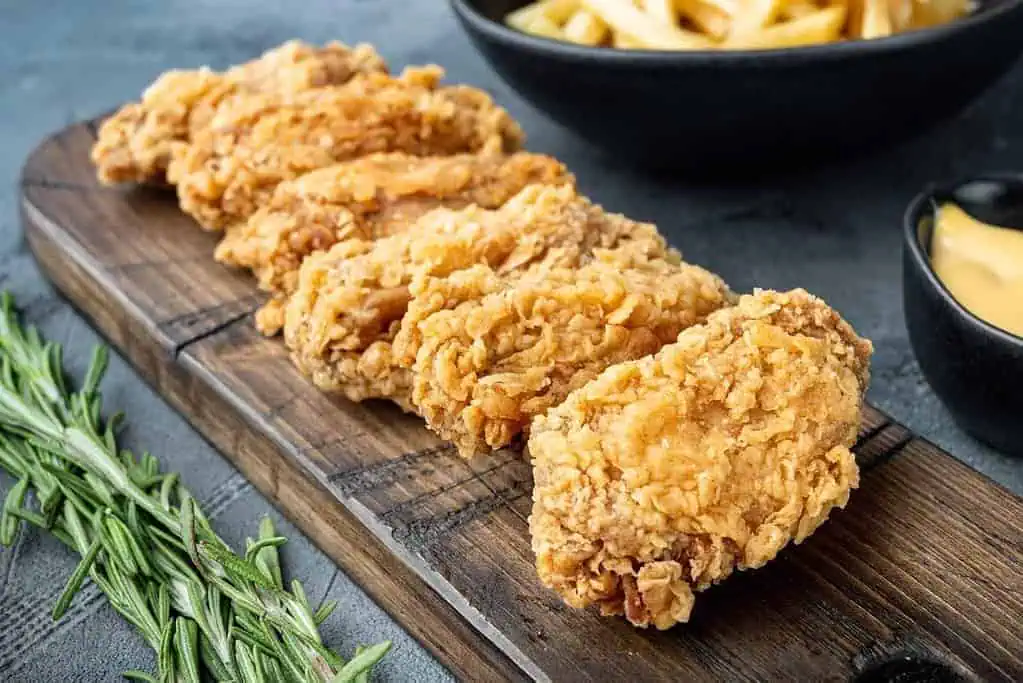 The Ultimate Chicken Wings Companion: 13 Mouth-Watering Side Dishes 6 Breaded chicken wings cuts on grey background.