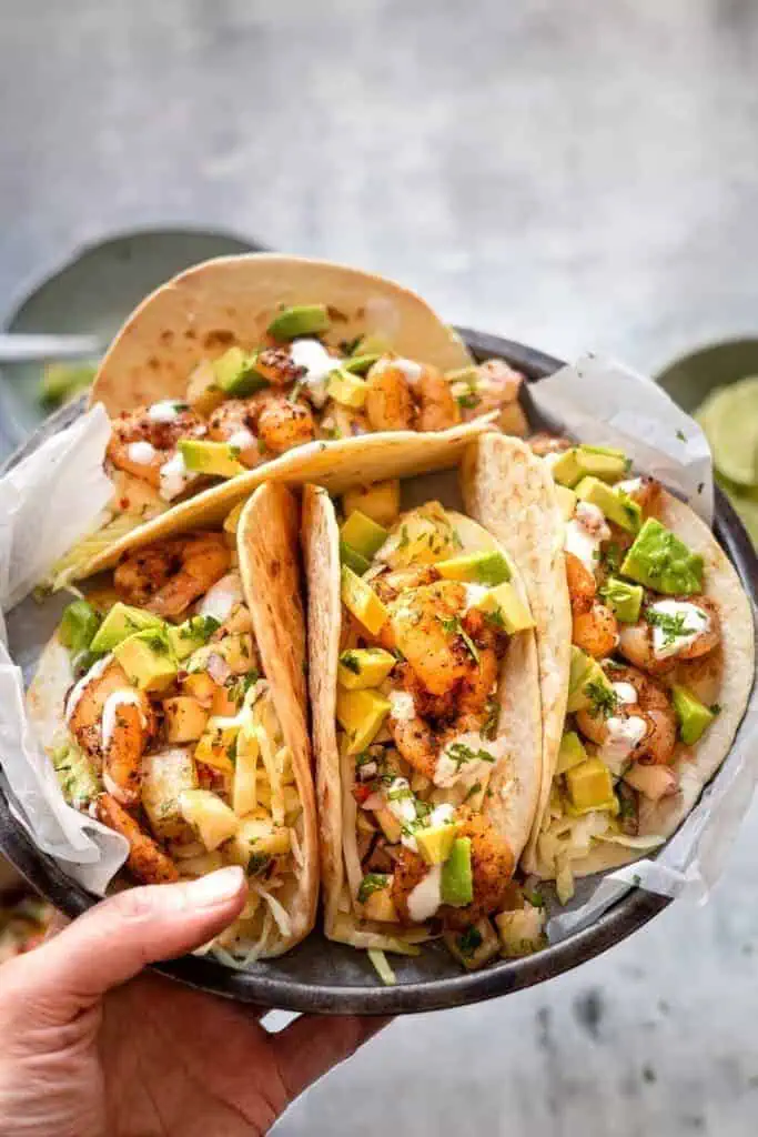 shrimp tacos with corn tortillas and taco sauce