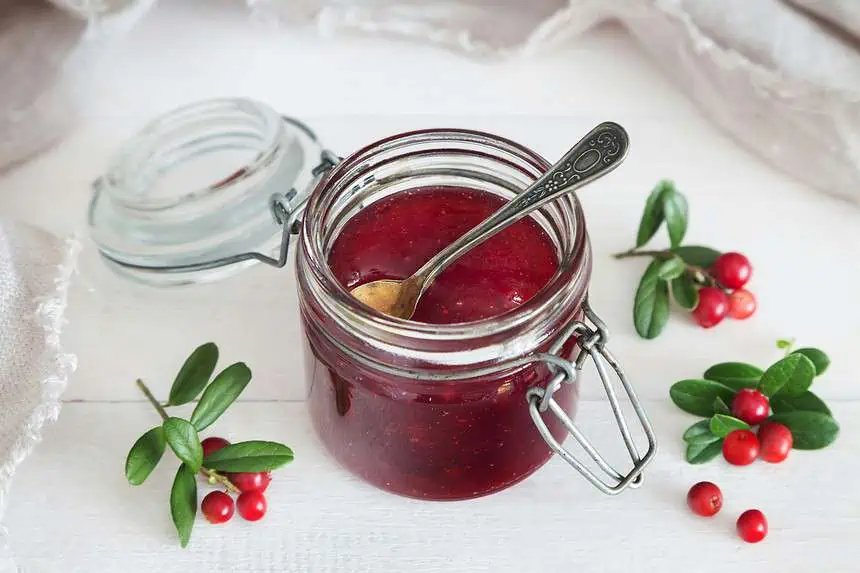 Is Jelly a Condiment? The Sweet Side of Seasoning 1 Homemade berry jelly in a glass jar with fresh berries