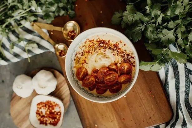 Photo of a bowl spread on top of wooden chopping board