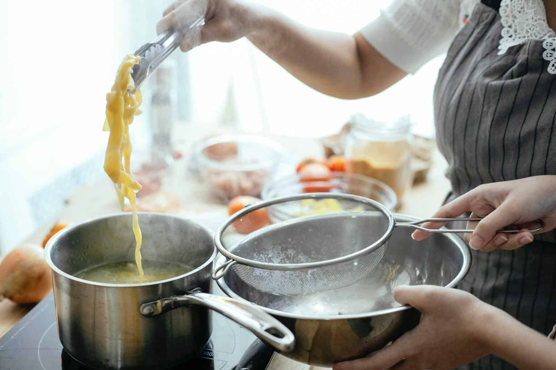Home Icy 41 Crop cooks preparing pasta in kitchen