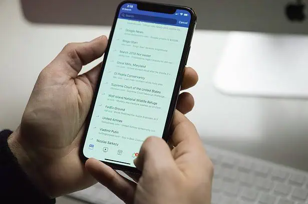 Person using Google Search on smartphone with a blurred background.