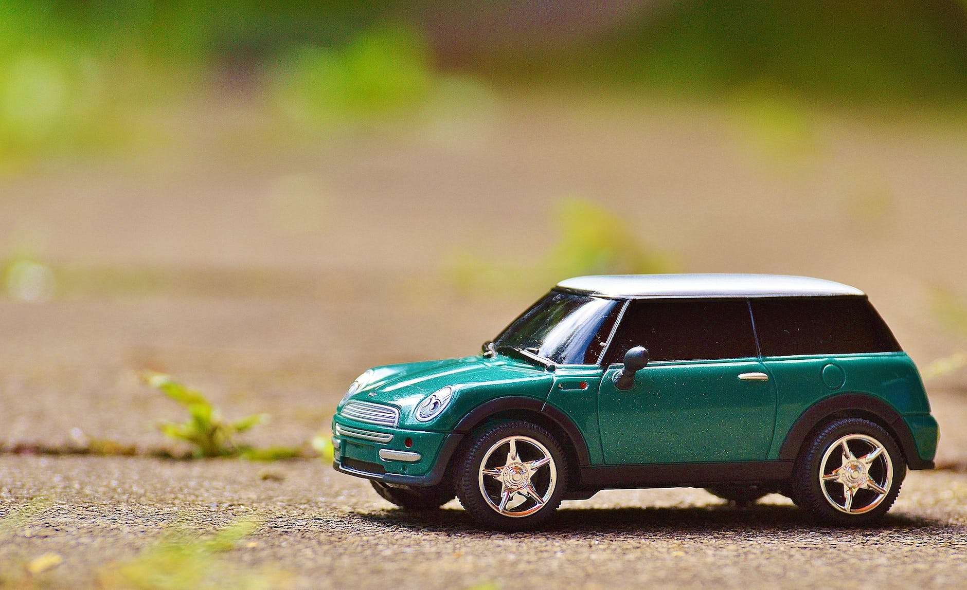 Home Icy 48 green scale model car on brown pavement
