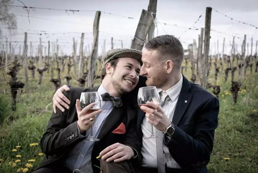 Deciphering Spectrum: A Guide To Understanding A Guy's True Sexuality 1 Gay couple having wine and laughing together