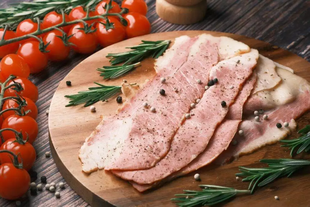 Raw meat kept on brown wooden chopper