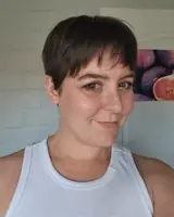 Woman with short hair smiling at gym, fitness, healthy lifestyle.