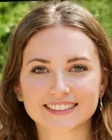 Bright smiling woman with natural makeup and long hair, showcasing confidence and happiness.