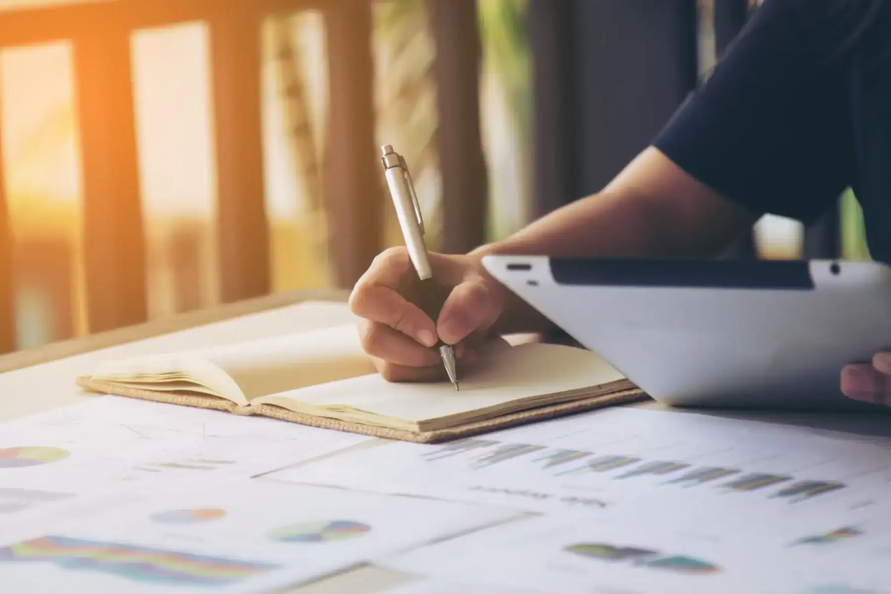 Professional woman signing business contract at office desk.