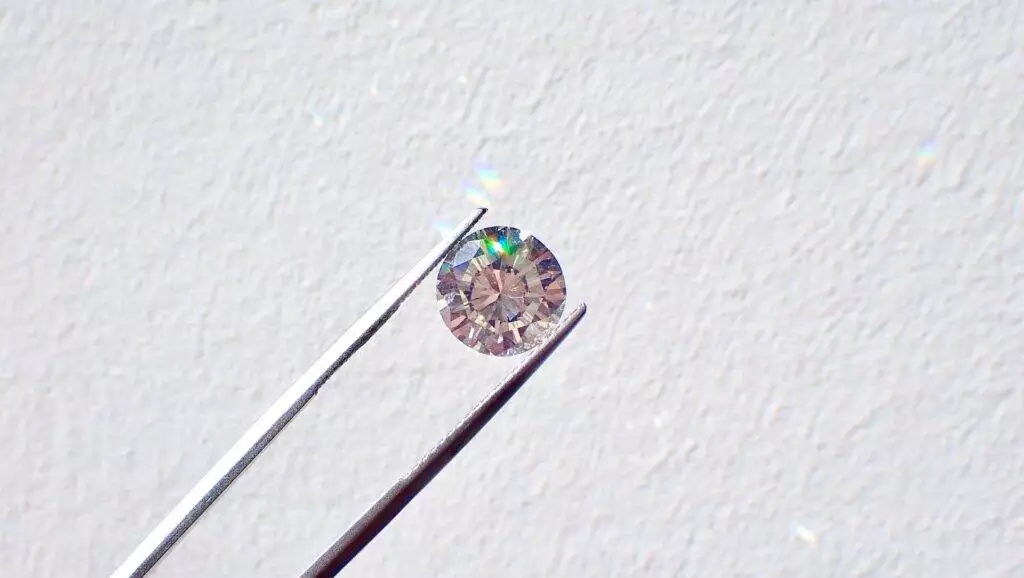 Gemstone Evolution: The Growing Popularity of Lab-Grown Diamonds 4 A close-up of a small diamond picked by a tool.