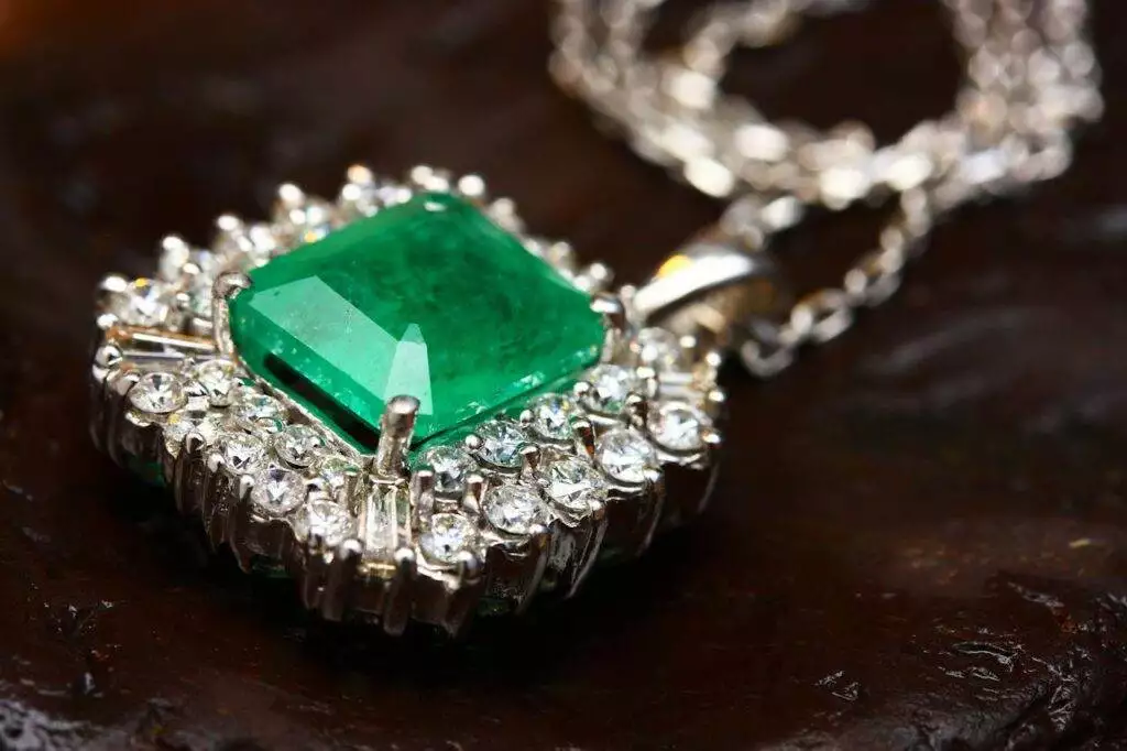 Gemstone Evolution: The Growing Popularity of Lab-Grown Diamonds 5 A close-up of a diamond necklace with a green gem in the centre.