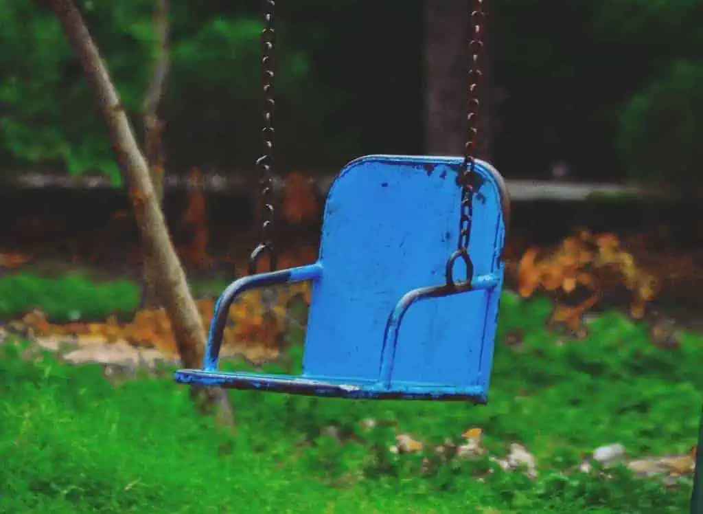 swing set with a blue metal chair and handle.