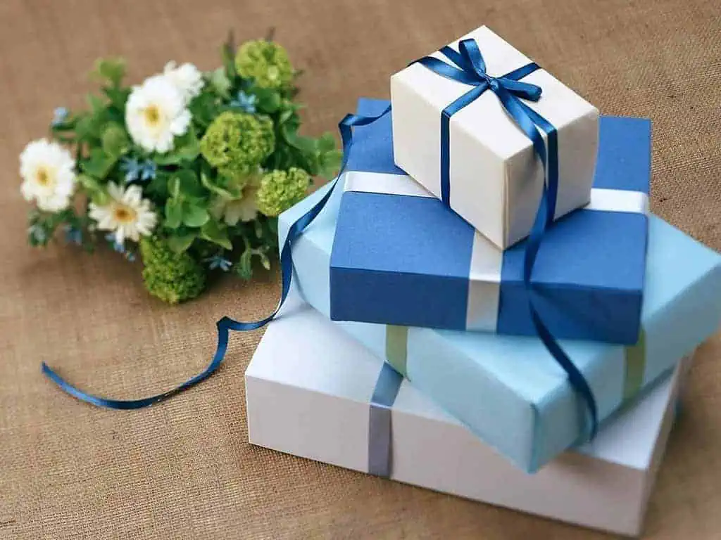 Unveiling the Significance of 12 Popular Christmas Symbols 7 Stacked Blue Colored Gift Boxes