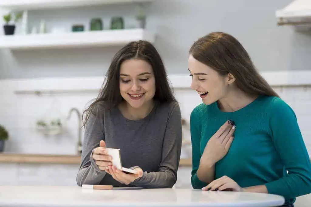 Two friends sharing beauty tips at home.