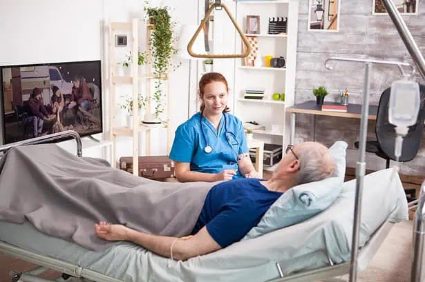 Nurse providing care to an elderly patient in a contemporary hospital setting.