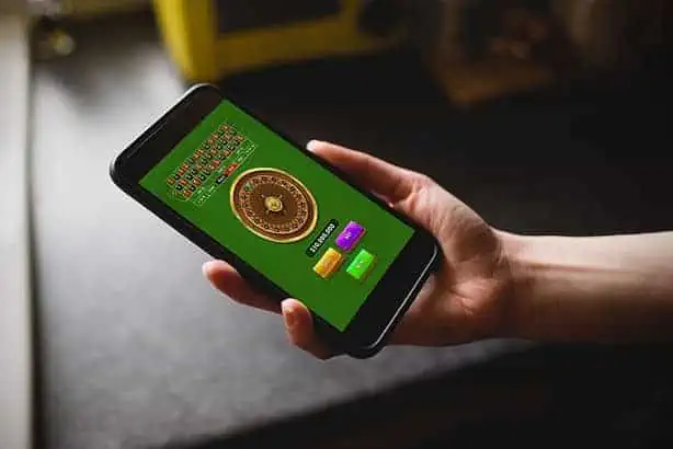 Person playing roulette on a mobile phone app.