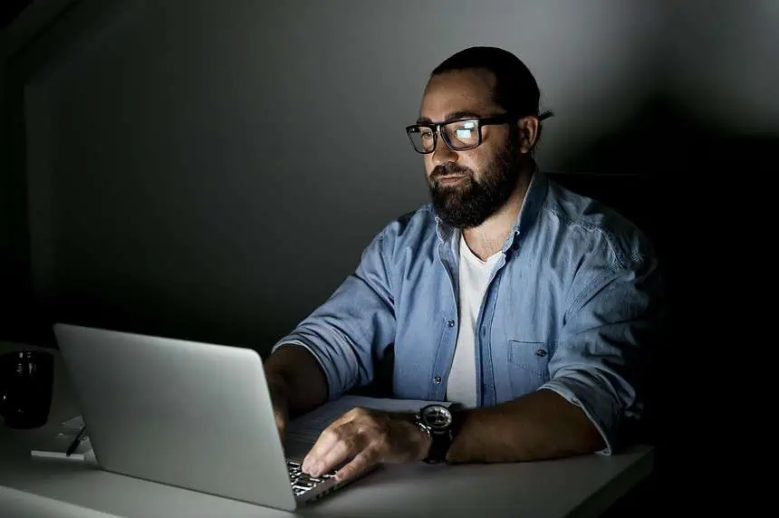 Professional working on laptop at night
