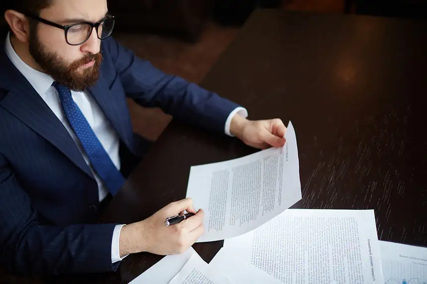 How Long Does Pre Litigation Take? Understanding The Duration Of Pre-litigation 1 Business professional analyzing paperwork for business or legal purposes.