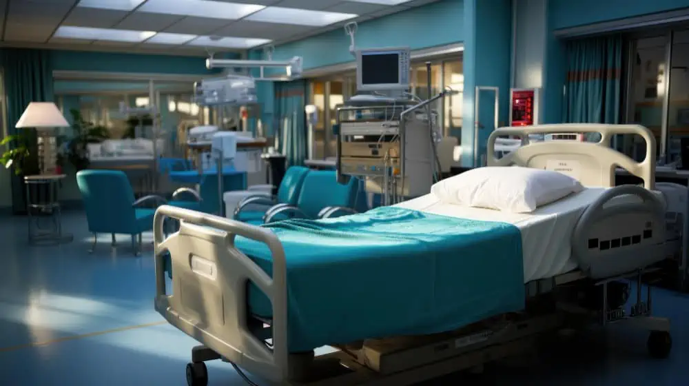 Hospital ICU with medical monitors, ventilators, and a patient bed in a modern healthcare setting.