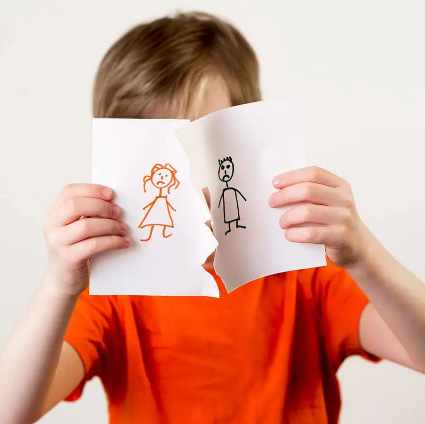 How To Win A Termination Of Parental Rights Case? 1 Child holding paper with drawings of a girl and boy, expressing emotions.