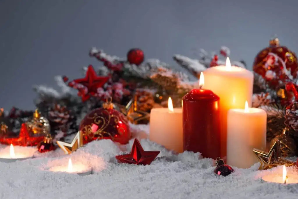 Unveiling the Significance of 12 Popular Christmas Symbols 6 Christmas candles with traditional decorative stars , red baubles , pine cones and green branches on snow