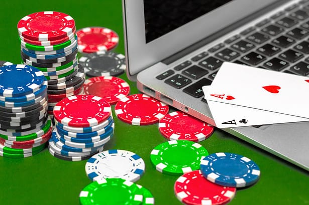 Online poker game with chips and laptop.