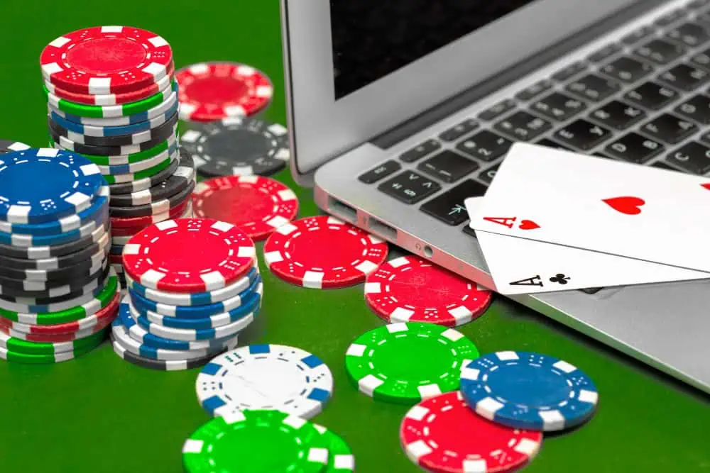 Online poker game with chips and laptop.