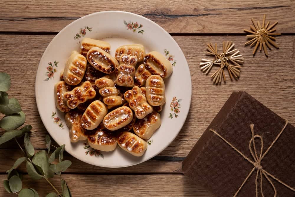 Home Icy 39 Delicious date-filled cookies arranged on a floral-patterned plate. Perfect for holiday celebrations.