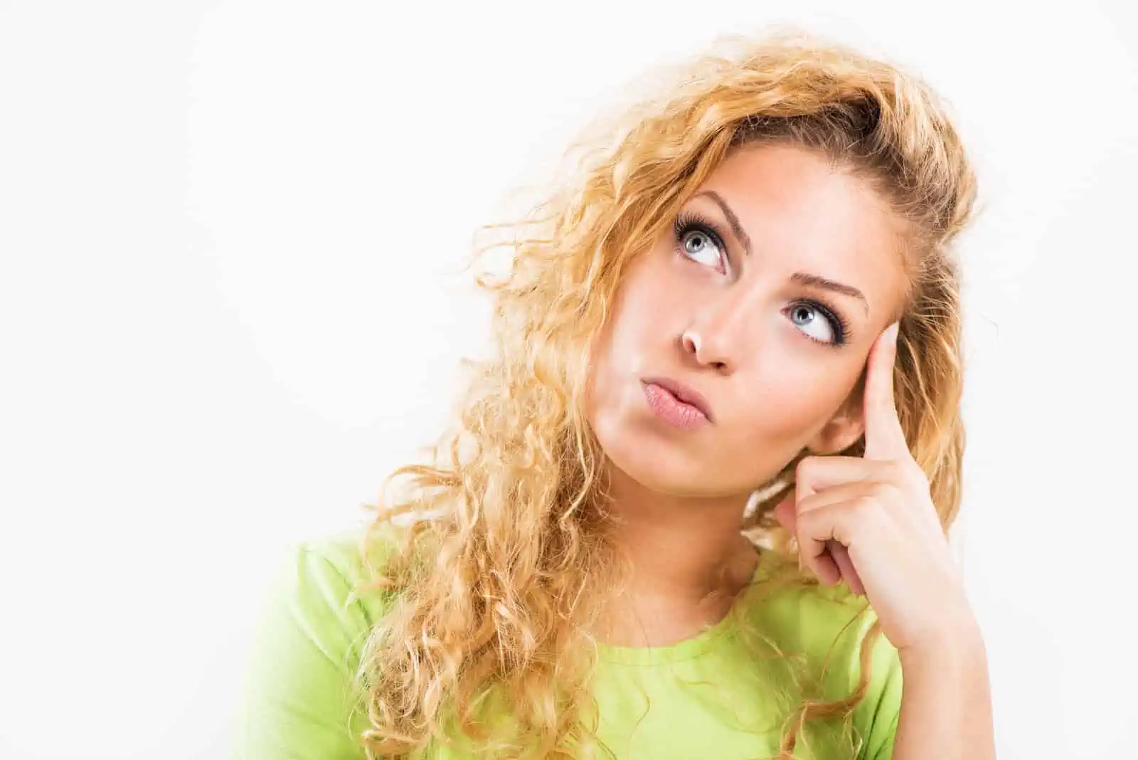 Woman thinking deeply with a curious expression.