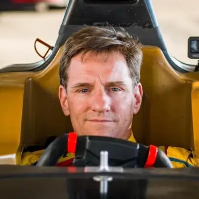Close-up of a male race car driver in the cockpit before a race.