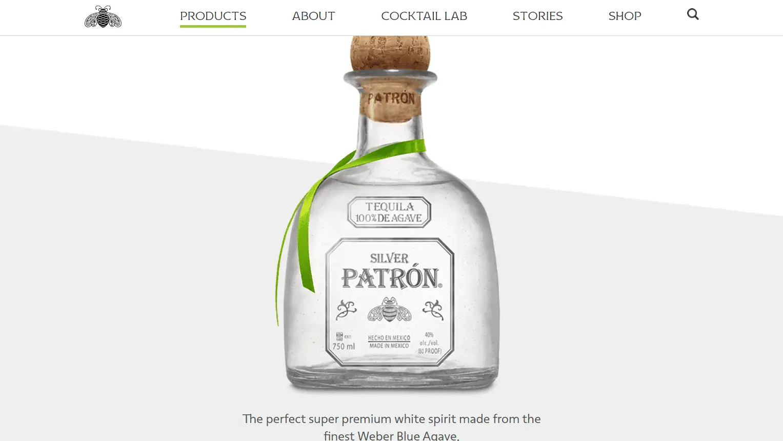 Close-up of Patrón Silver tequila bottle with green ribbon.