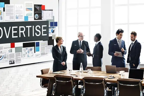 Advertising strategy meeting in a modern office with business professionals discussing marketing pla.