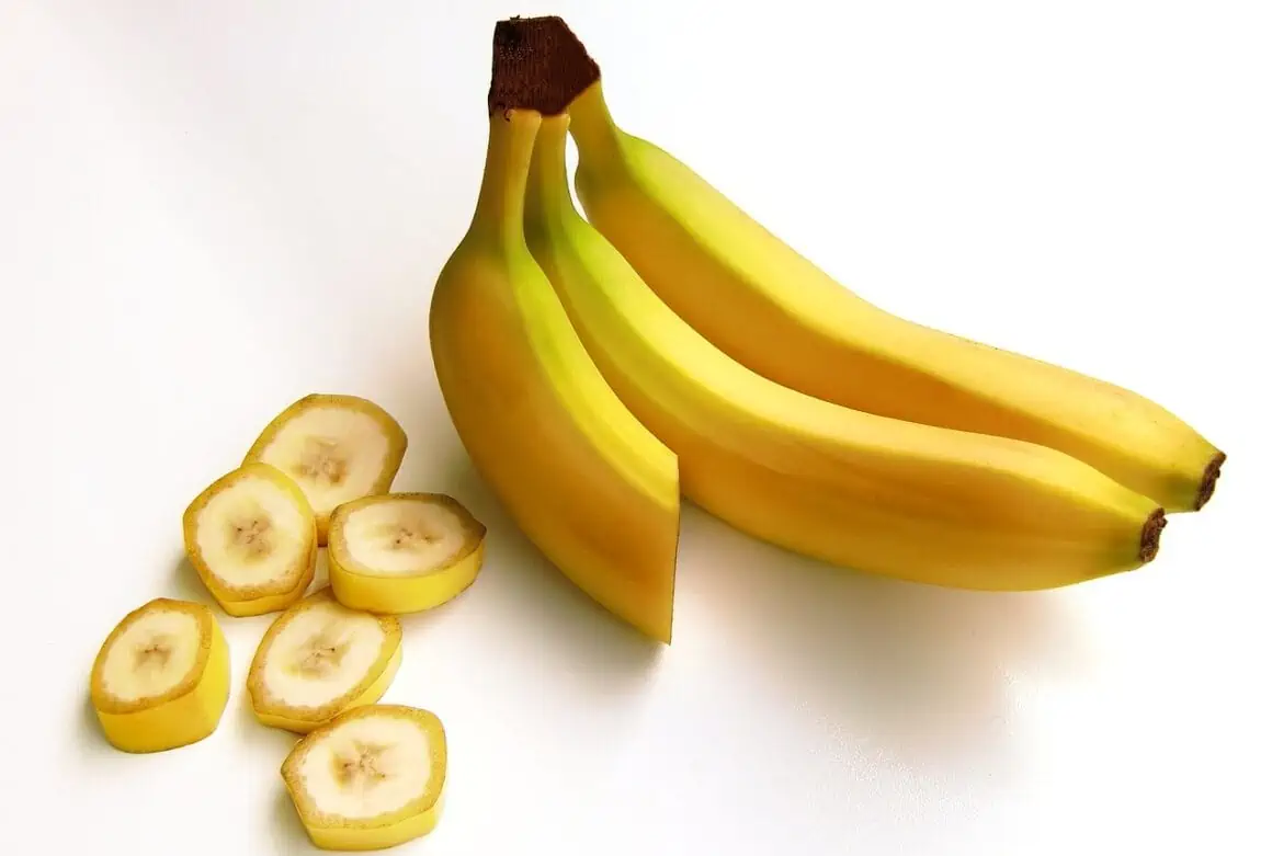Bananas with sliced pieces, fresh and ripe, on a white background.