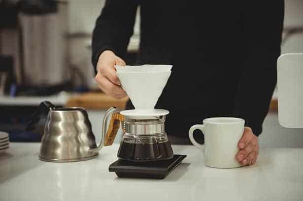man brewing coffee