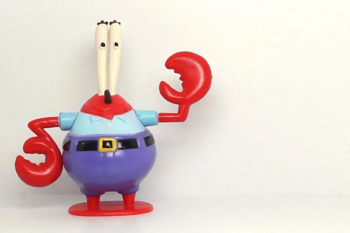 SpongeBob figurine with red claws, blue shirt, and purple pants, showcasing a playful character from.