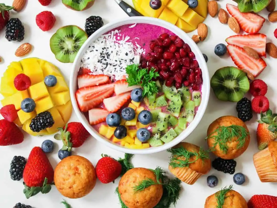 Vibrant fruit smoothie bowl topped with berries, kiwi, and mango for a healthy snack.