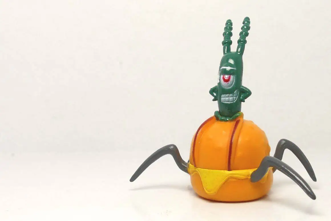 Playful insect figurine with orange and green colors, detailed with multiple eyes and antennae.
