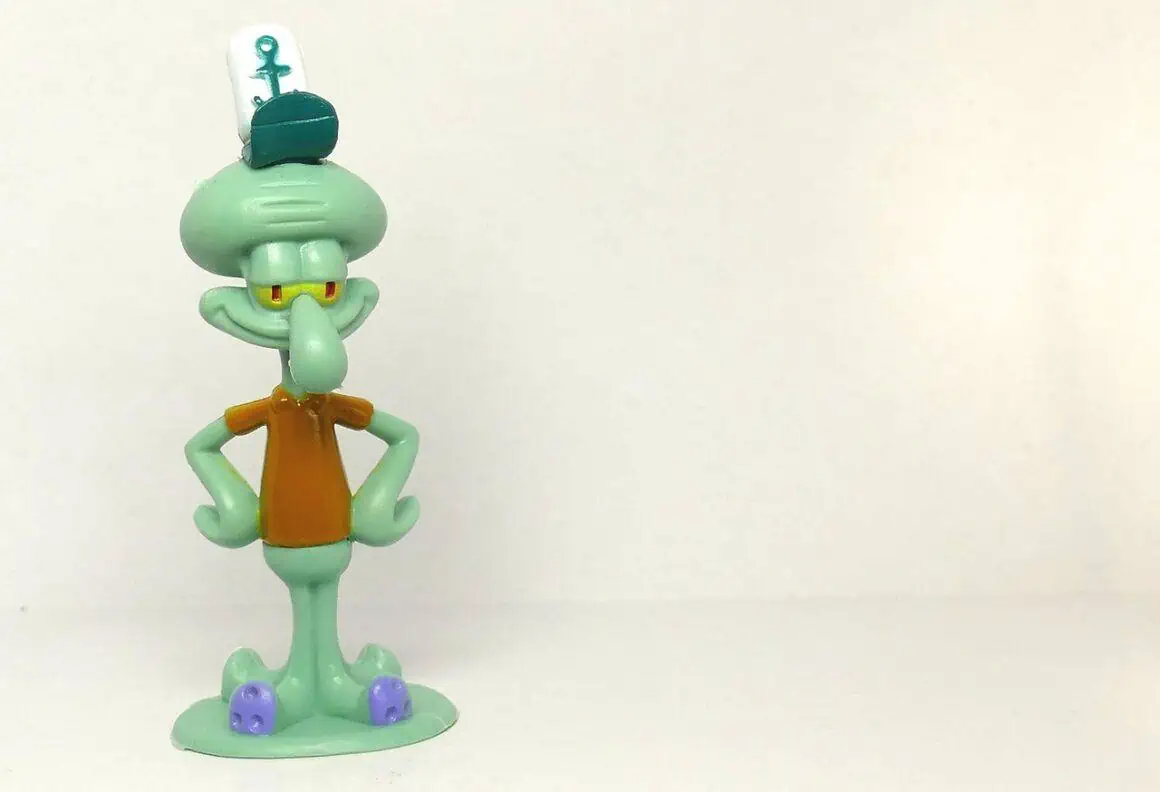 Cartoon SpongeBob figurine with a sailor hat and big smile.