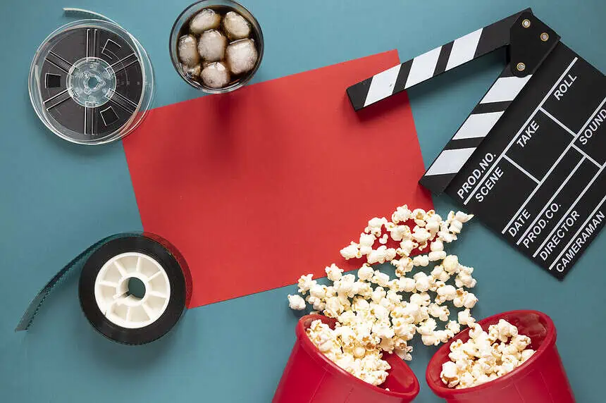 Cinematic essentials including popcorn, film reel, and clapperboard for movie lovers.