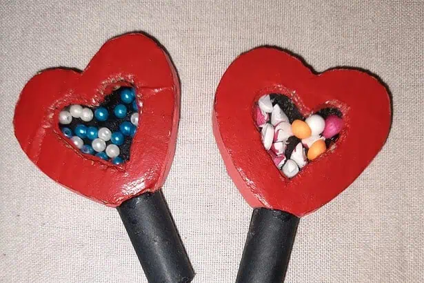 Heart-shaped candy dispensers filled with colorful candies, perfect for Valentine's Day treats.