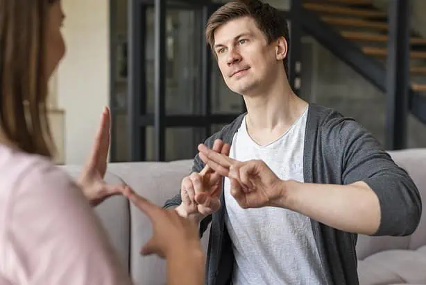 Young couple arguing calmly at home, practicing conflict resolution skills.