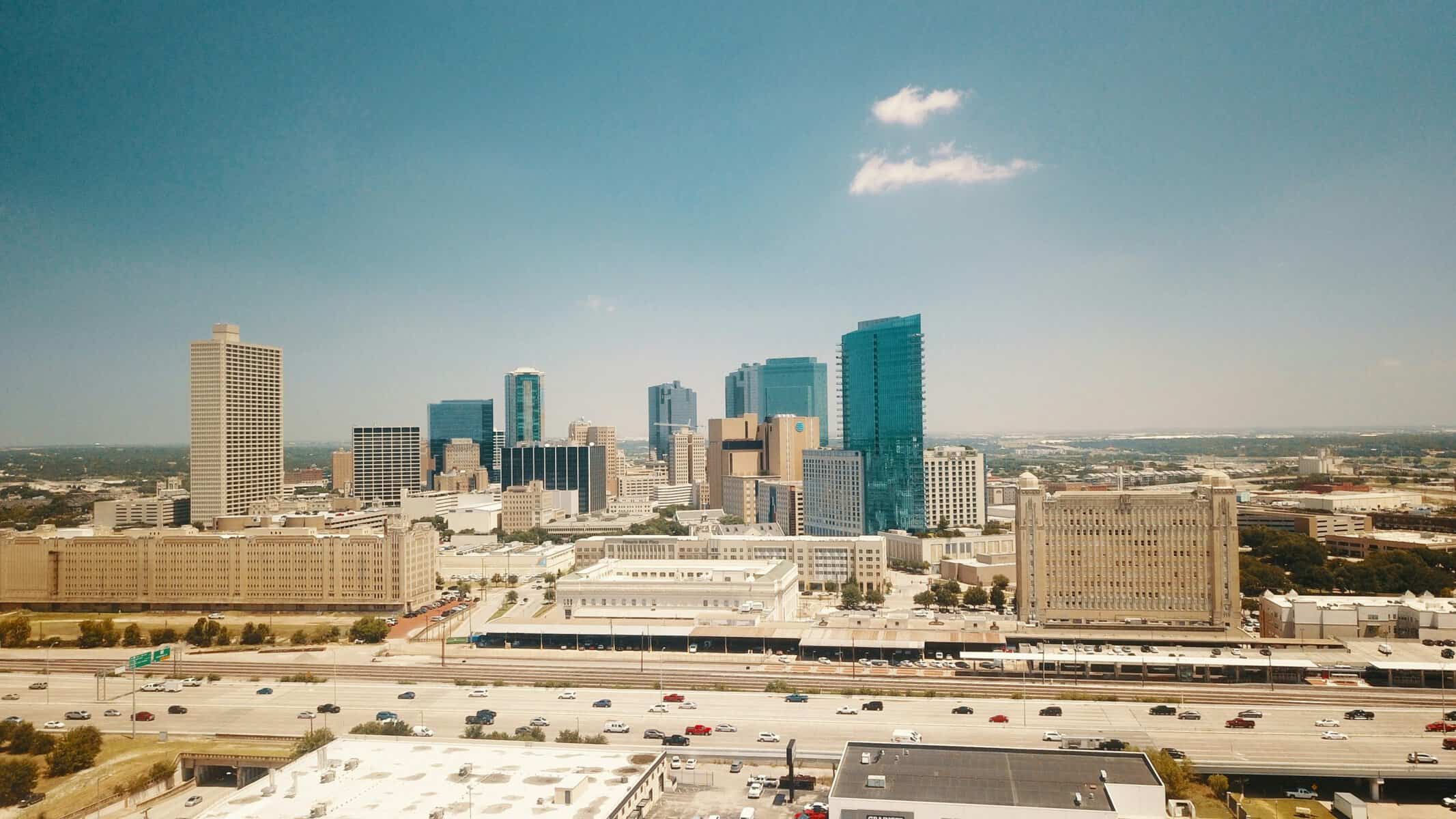 City skyline with tall buildings and clear blue sky.