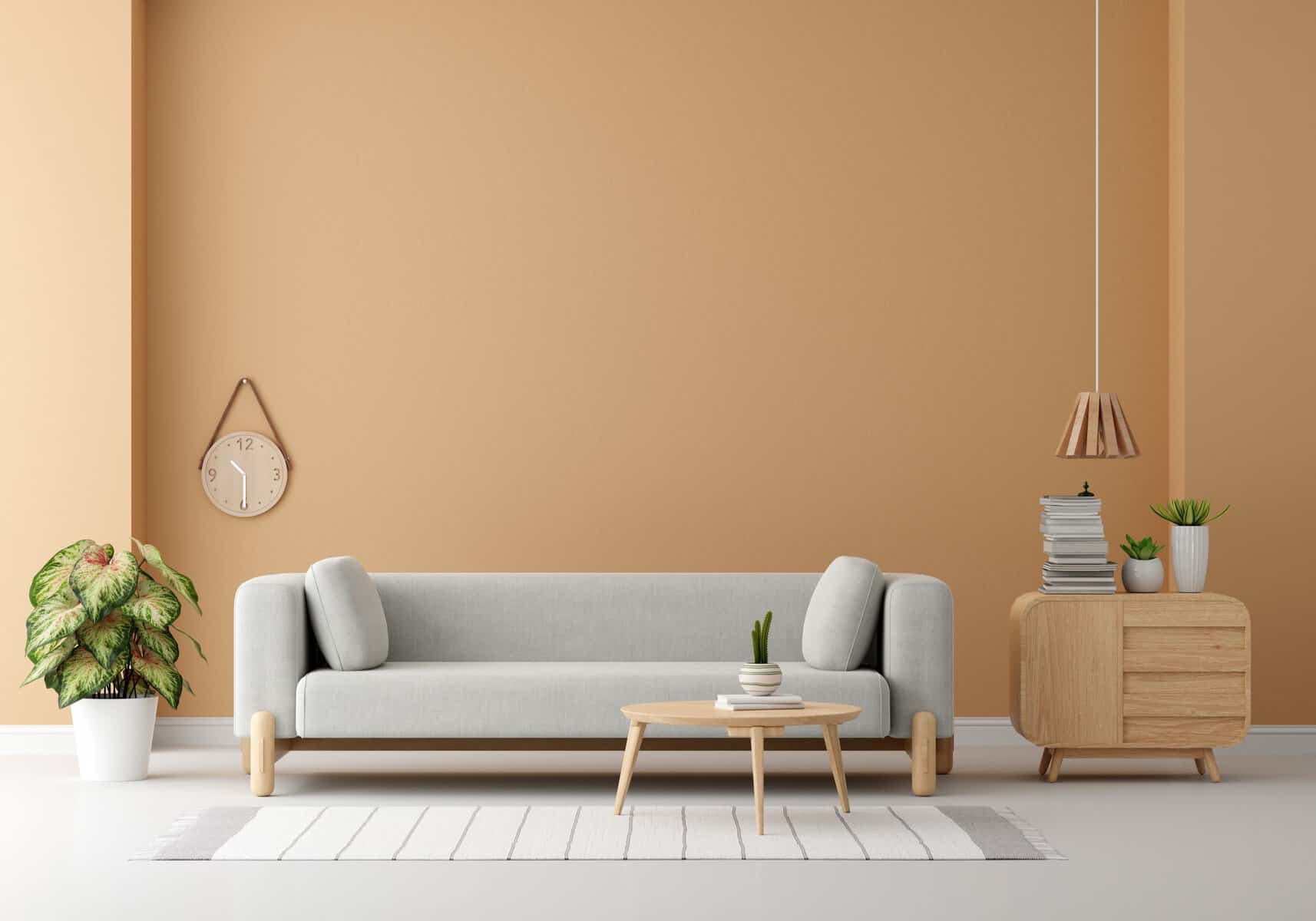 Home Icy 39 Elegant living room with beige walls, white sofa, wooden side table, and potted plants.