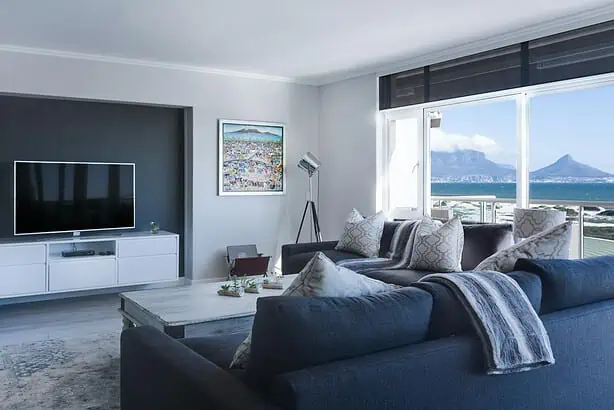 Living room with large windows overlooking the sea and mountains.