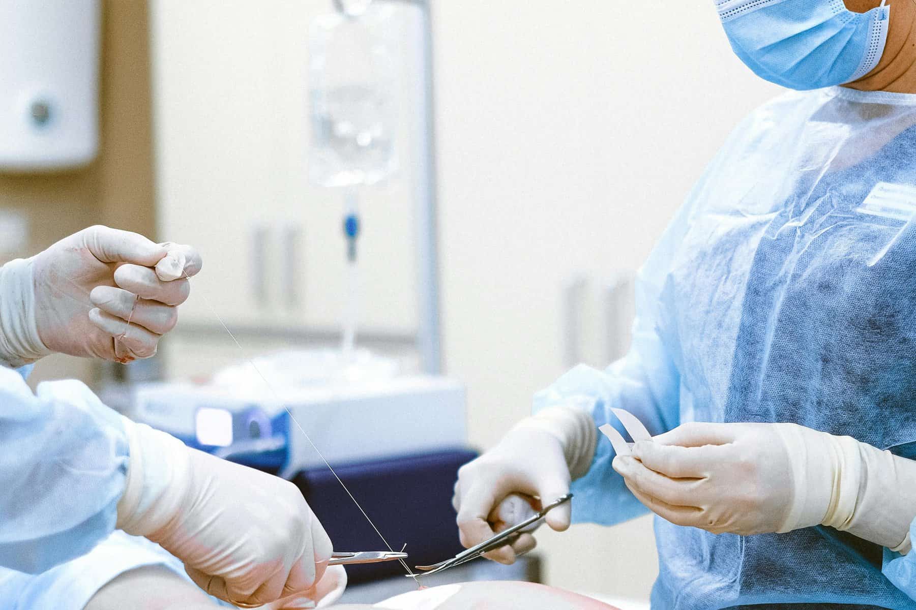 Medical team performing surgery in hospital operating room.
