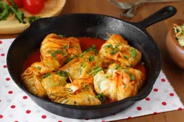 Chicken shawarma served in a cast-iron skillet with herbs and spices.
