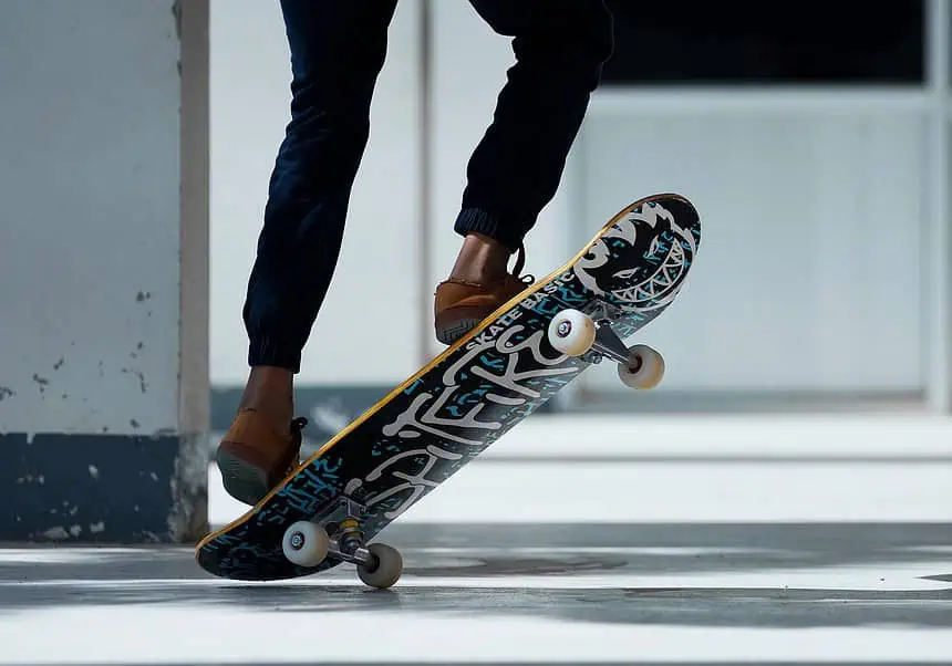 Skateboarder performing a trick on a skateboard in an urban setting.