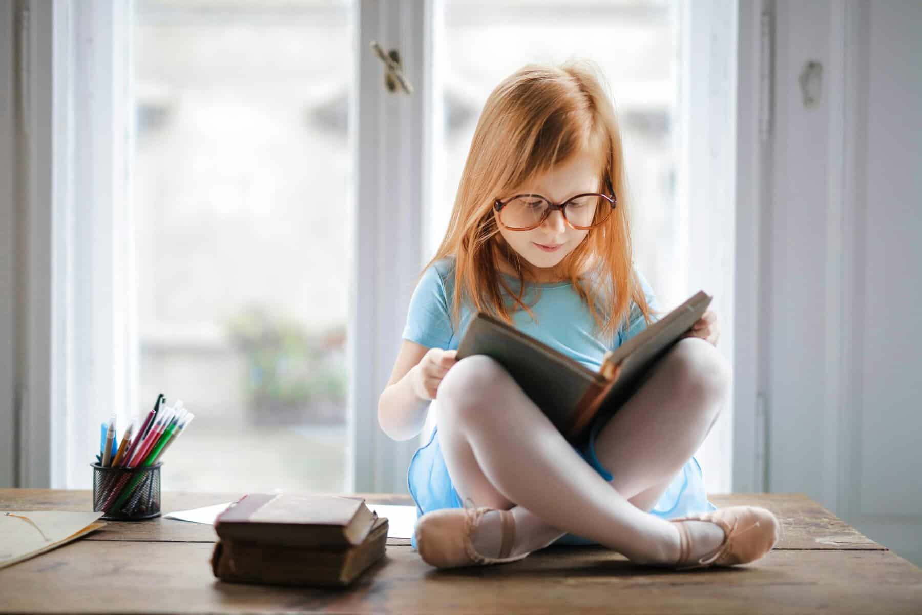 Home Icy 42 Girl reading a book by the window, enjoying a quiet moment indoors.