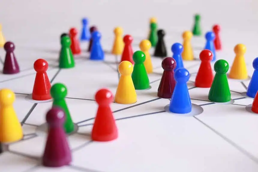 5 Reasons to Indulge in Analog Gaming 1 Colorful game pieces representing teamwork and strategic planning on a white surface.