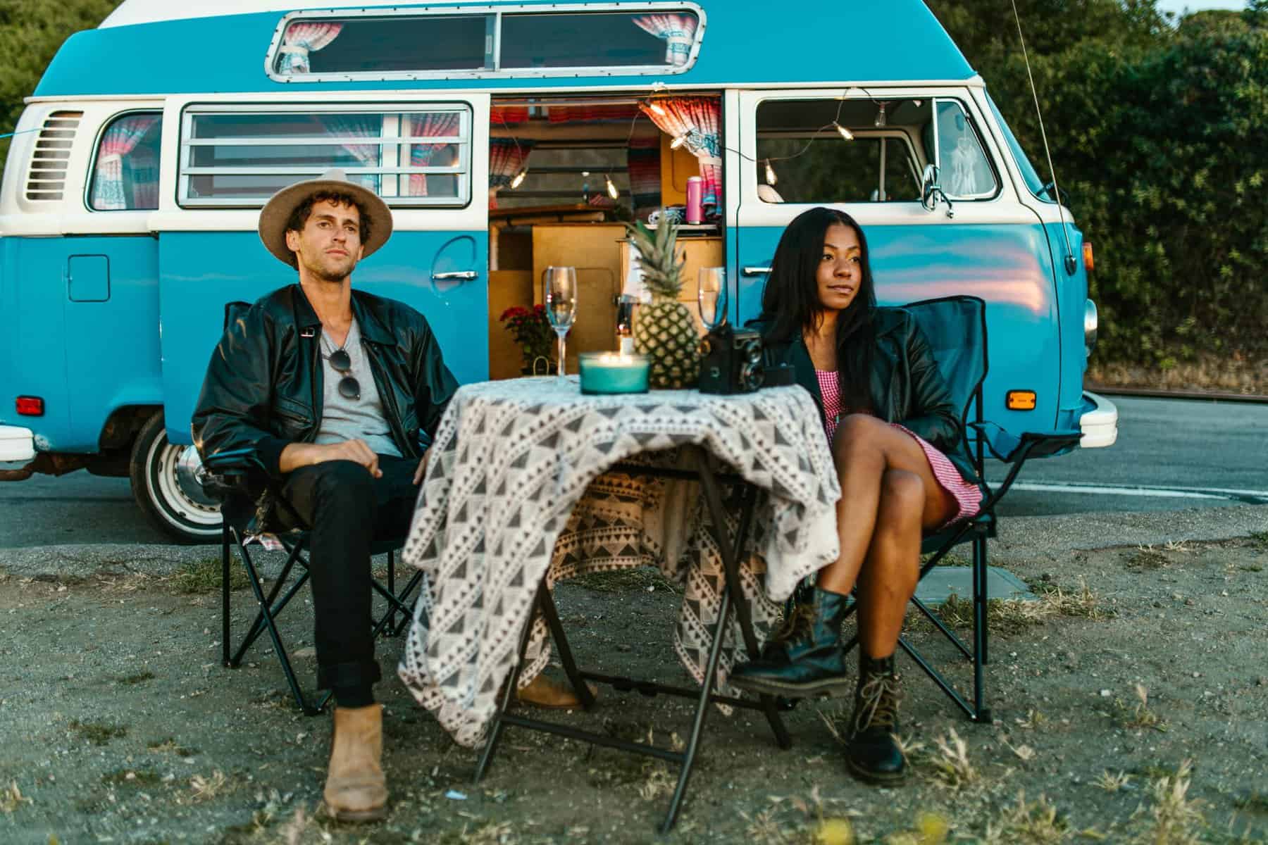 Home Icy 43 Vintage camper van with a couple enjoying a roadside picnic.