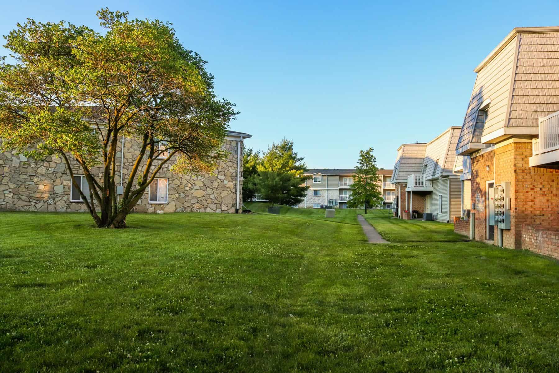 Peaceful suburban area featuring well-maintained lawns and charming houses.